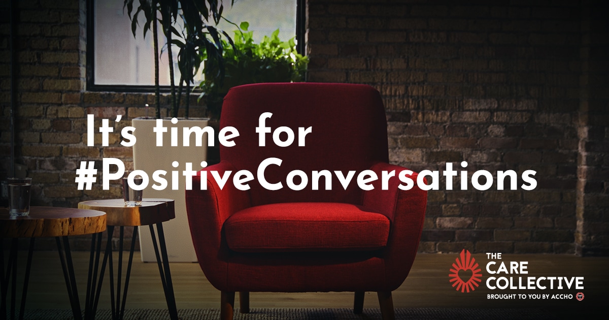 Red chair against a brick wall with plants in the background. Text overlay says, "It's time for positive conversations"